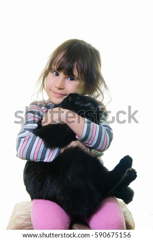 Happy little girl hugging lovely kitten. Cute child playing with her cat, isolated on white background