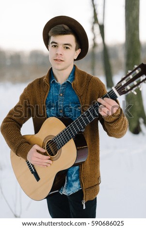 stylish boy with a camera, portrait, winter background