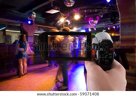 Dancing people in an underground club on the camera