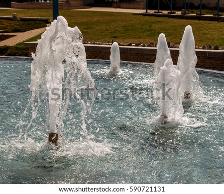 modern fountain in the city park on a summer area. Odessa, Yuzhny, cascade system of urban fountains on the main square on a sunny summer day