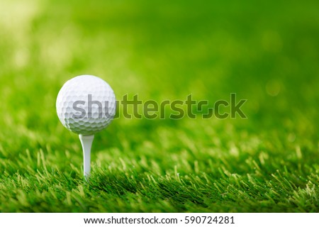 Golf ball on tee ready to be shot Royalty-Free Stock Photo #590724281