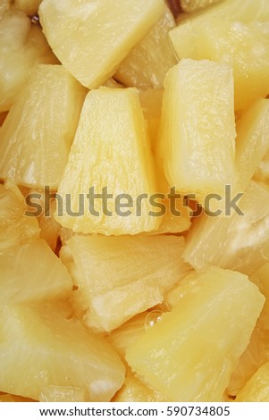 
Pineapple slices as background. Yellow pineapples texture pattern.
