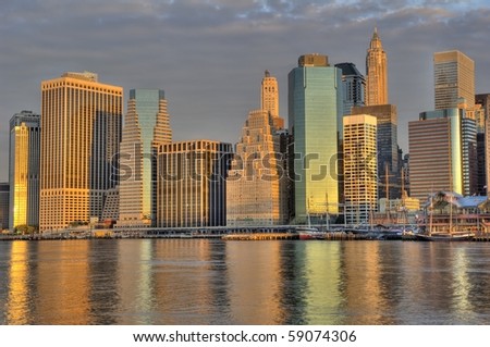 A stunning image of downtown Manhattan skyline photographed at sunrise. HDR composite of three exposures.