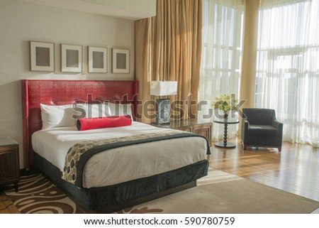 hotel room with king bed and natural light