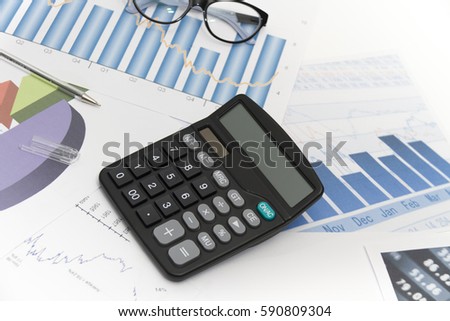 Photo of the Businessman analyzing investment charts with calculator and laptop