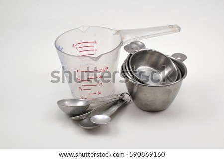 measuring cup and measuring spoon  on white background. Royalty-Free Stock Photo #590869160