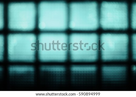 Abstract blurred blue background of glass block wall .
