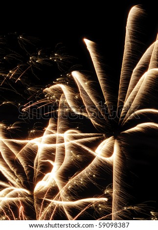 Many streaks with feathery motion blur from bursts of low-altitude fireworks