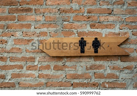 Toilet sign with old red brick wall background