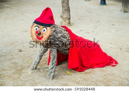 Red wooden Tio de Nadal christmas mascot in Barcelona Royalty-Free Stock Photo #591028448