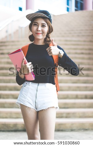 Smiling college student sitting on staircase