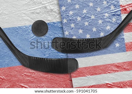 Hockey puck, hockey sticks and the American image, and the Russian flag on the ice. Concept