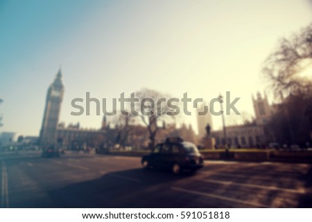 Defocused background of London traffic near Big Ben of Westminster in rush hour.