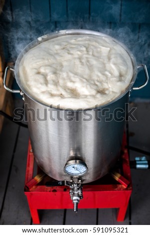 Homebrewing Hot Break and lot of Protein Froth on to of the Boil Kettle Warming up to a Boiling Temperature.