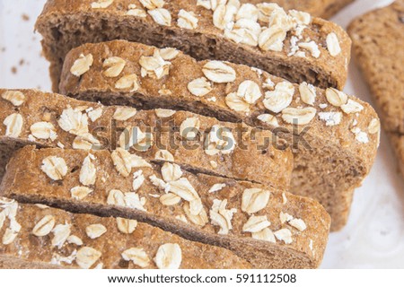 Fresh whole grain bread on white wood background