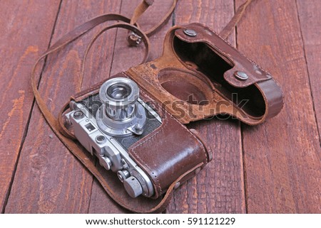 Vintage old film photo-camera in leather case.