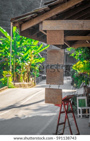 vintage and rustic Wooden board sign in front of the restaurant and coffee shop door in the countryside