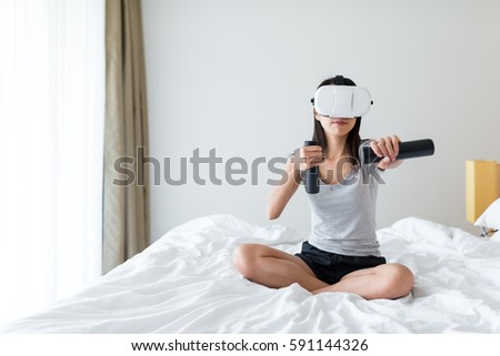 Woman play game on virtual reality device in living room