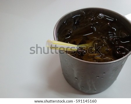 Chinese green tea with ice and straw in traditional stainless steel cup