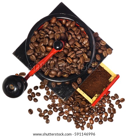 Old antique wooden coffee grinder with coffee beans and ground coffee. Coffee grinder hand-painted in black, red and blue. The device isolated on a white background with light shadow and reflection.