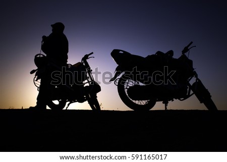 a man silhouette with bikes