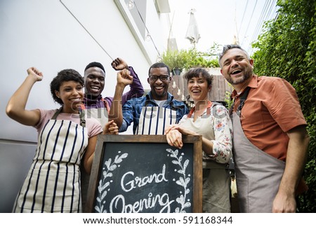 Diverse People with Grand Opening Sign First Day of Business