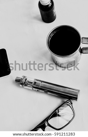 Vaping set and coffee on the white background. Hipster or businesman style. Trendy objects with copy space on the wooden background