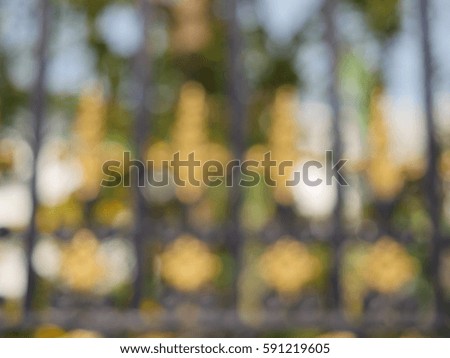 blurred alloy fence background.
