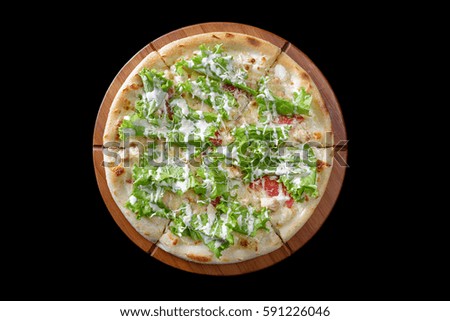 Pizza on a wooden board on a black background