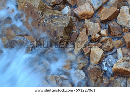 Stone in sea with wave background