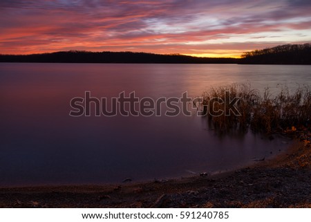 Shoreline image of a predawn sunrise at Lake Jacomo located in the Kansas City, Missouri metro are.  