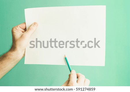paper and pencil in hand