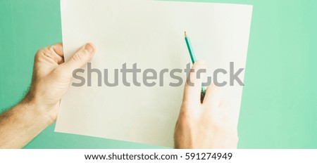 paper and pencil in hand