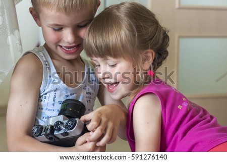 Children boy and girl brother and sister playing with cameras. Family relations concept.