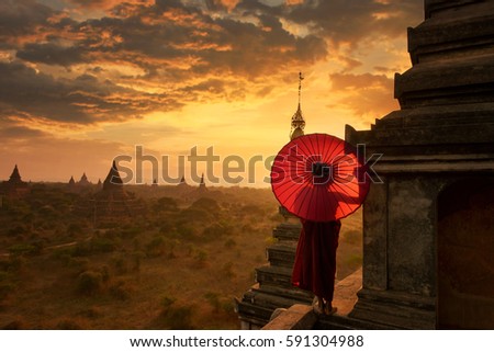 Novice Monk relaxing in ancient temple bagan on during sunset ,Myanmar
