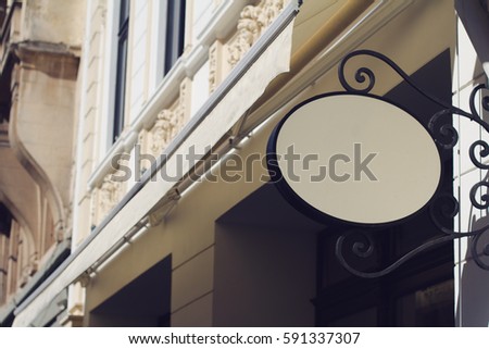 Horizontal front view of empty round signage on a building with classical architecture