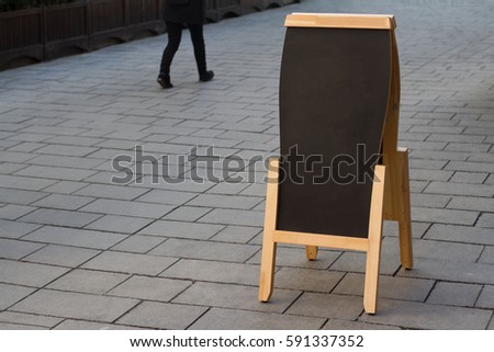 horizontal blank black wooden restaurant sidewalk chalkboard on a street with people passing by