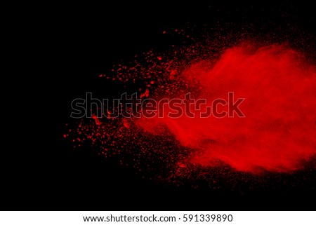 abstract red powder explosion on  black background.abstract red powder splatted on black background. Freeze motion of red powder exploding.