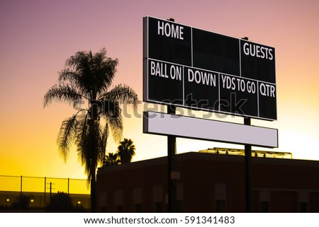 SCOREBOARD IN A SUNSET CALIFORNIA WITH A PALM TREE SILHOUETTE