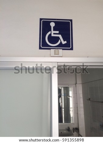 Symbol "priority of wheelchair" in front of the rest room/toilet.