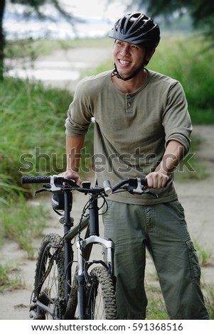 Man with bicycle, outdoors