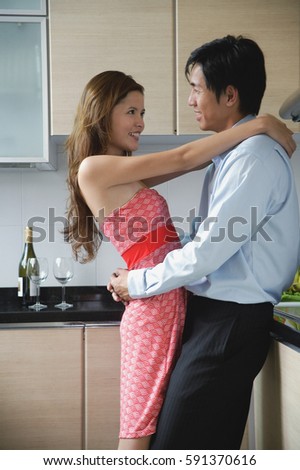 Couple at home, embracing in kitchen