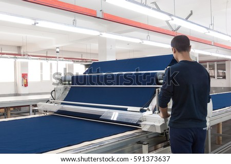 equipment for the preparation of cloth at a garment factory Royalty-Free Stock Photo #591373637