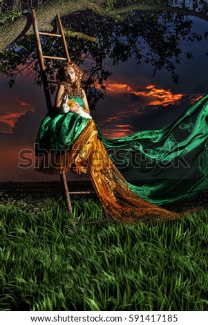 fairy tale ,beautiful woman on stair,petting  a rabbit ,colorful sunset sky ,green and orange dress,lamps around scenery,fantasy photography 