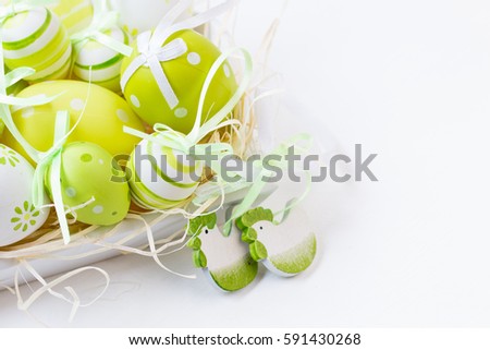 Easter decorative eggs,wooden chicken shaped decoration.Yellow,green,white. Background. Selective focus. Closeup photo. Easter concept.Copy space.
