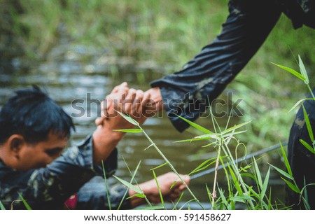Military  ,  Army loyalty oath  ,  Soldier shaking hands on outdoor background.