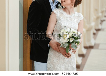 Groom hugging his bride