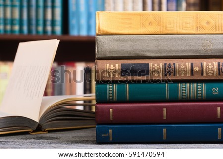 Old books in the Library on wooden background