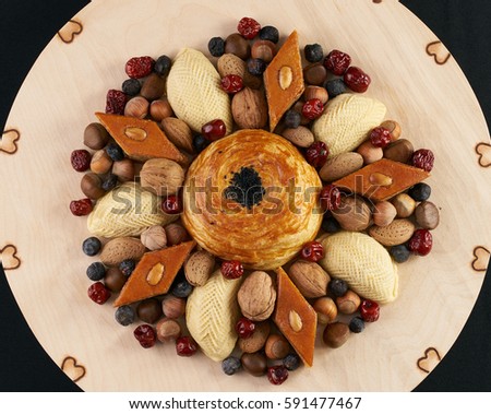 Spring holiday Novruz in Azerbaijan.  Easter and traditional sweets baklava, shekerbura, gogal ,nuts , dates on wooden table.