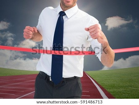 Digital composite image of a businessman winning the race on race track
